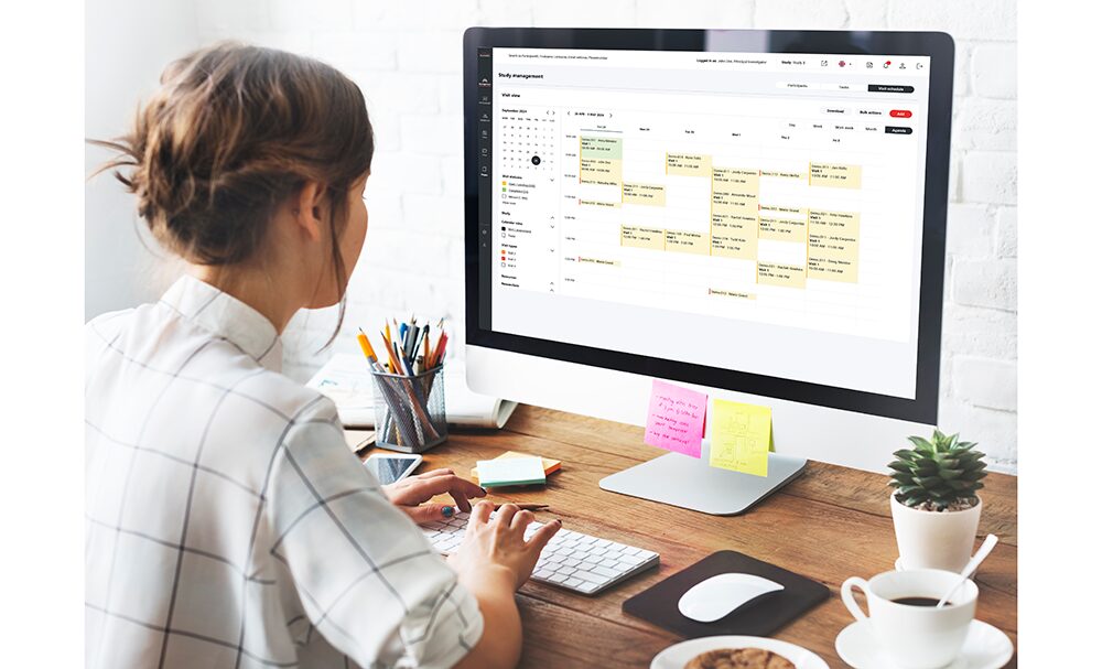 woman using Almac Visit Managemnet on computer